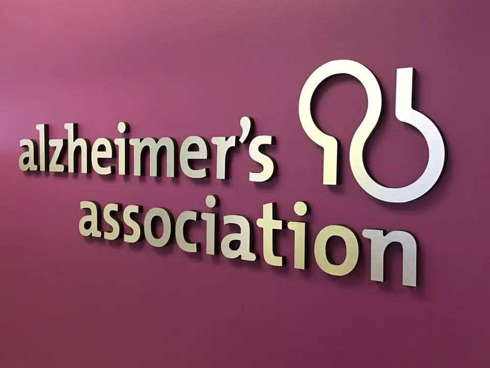 Raised Alzheimer’s Association logo on a purple accent wall
