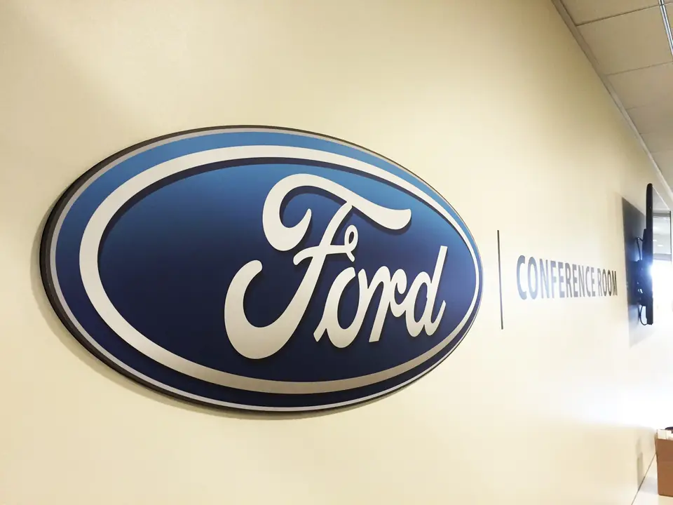 Oval Ford logo sign beside a conference room